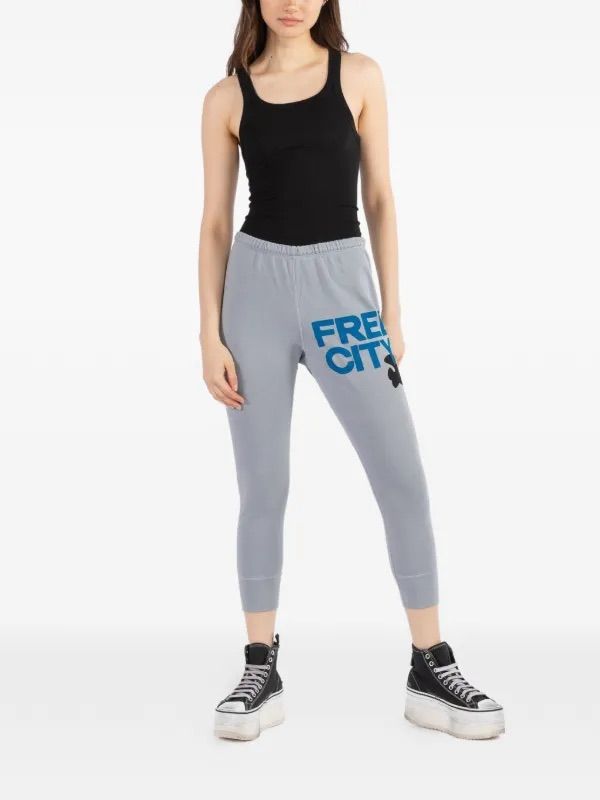 FREE CITY light blue drop crotch cropped sweatpants, blue writing black bird