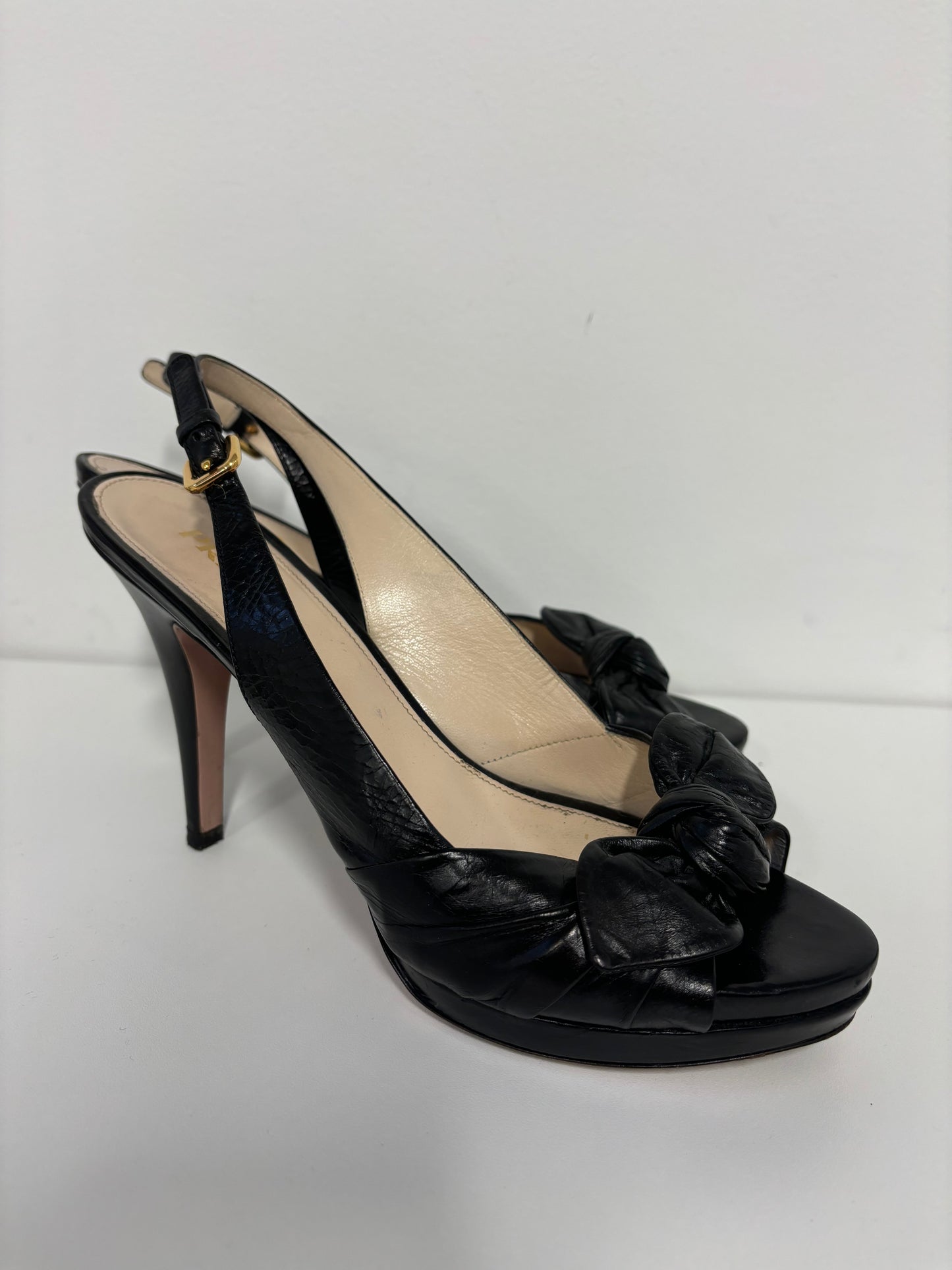 PRADA black ankle strap pumps with floral detail